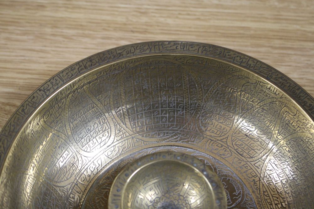 A large brass Persian magic bowl, Qajar dynasty, with inscribed decoration, diameter 21cm